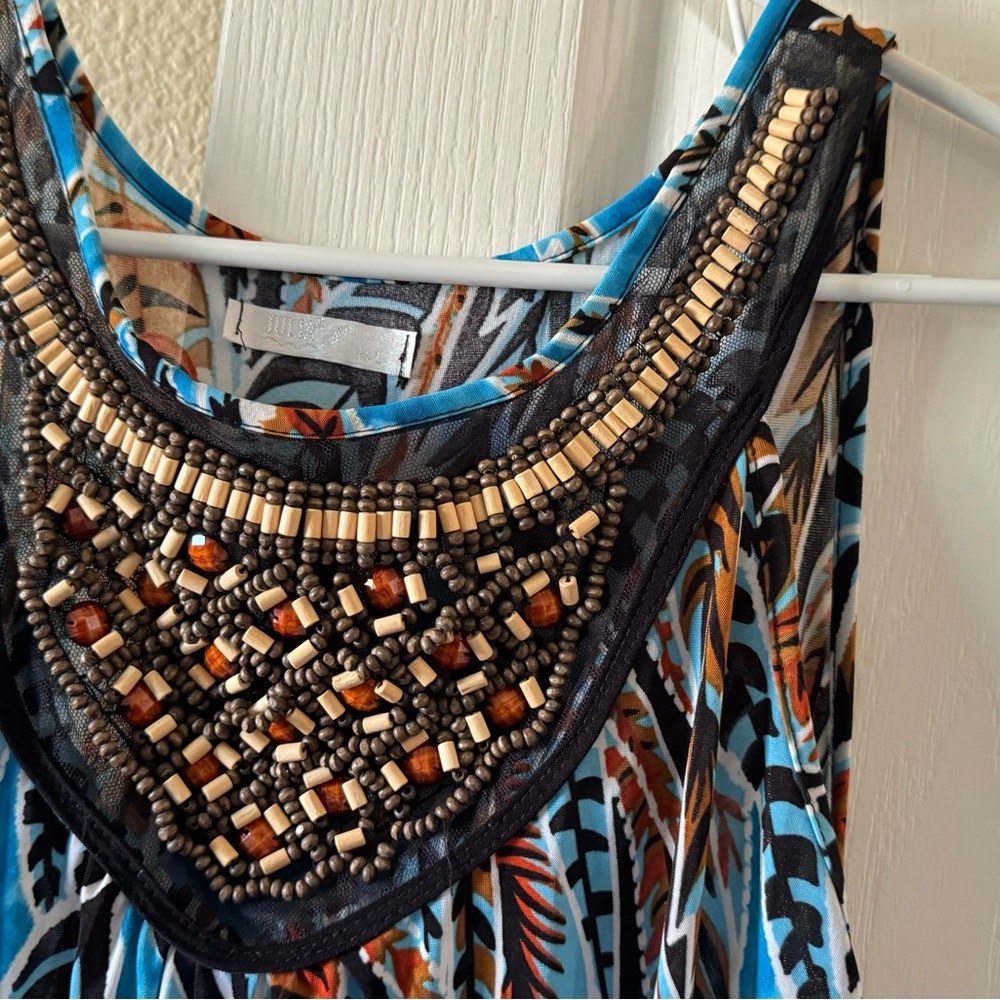 Long dress needs a new loving home .has great bead work !